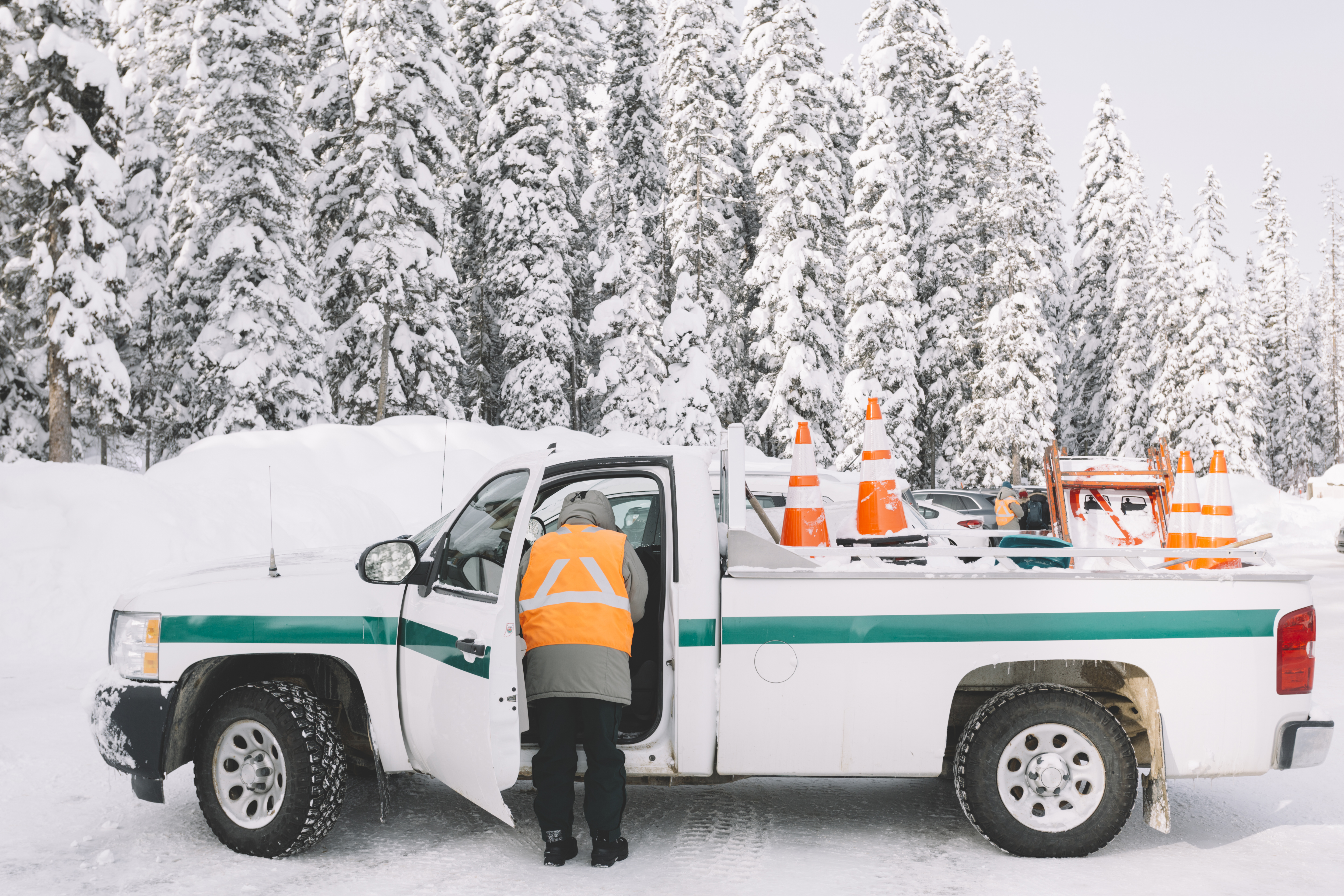 person-standing-near-car-with-traffic-cones